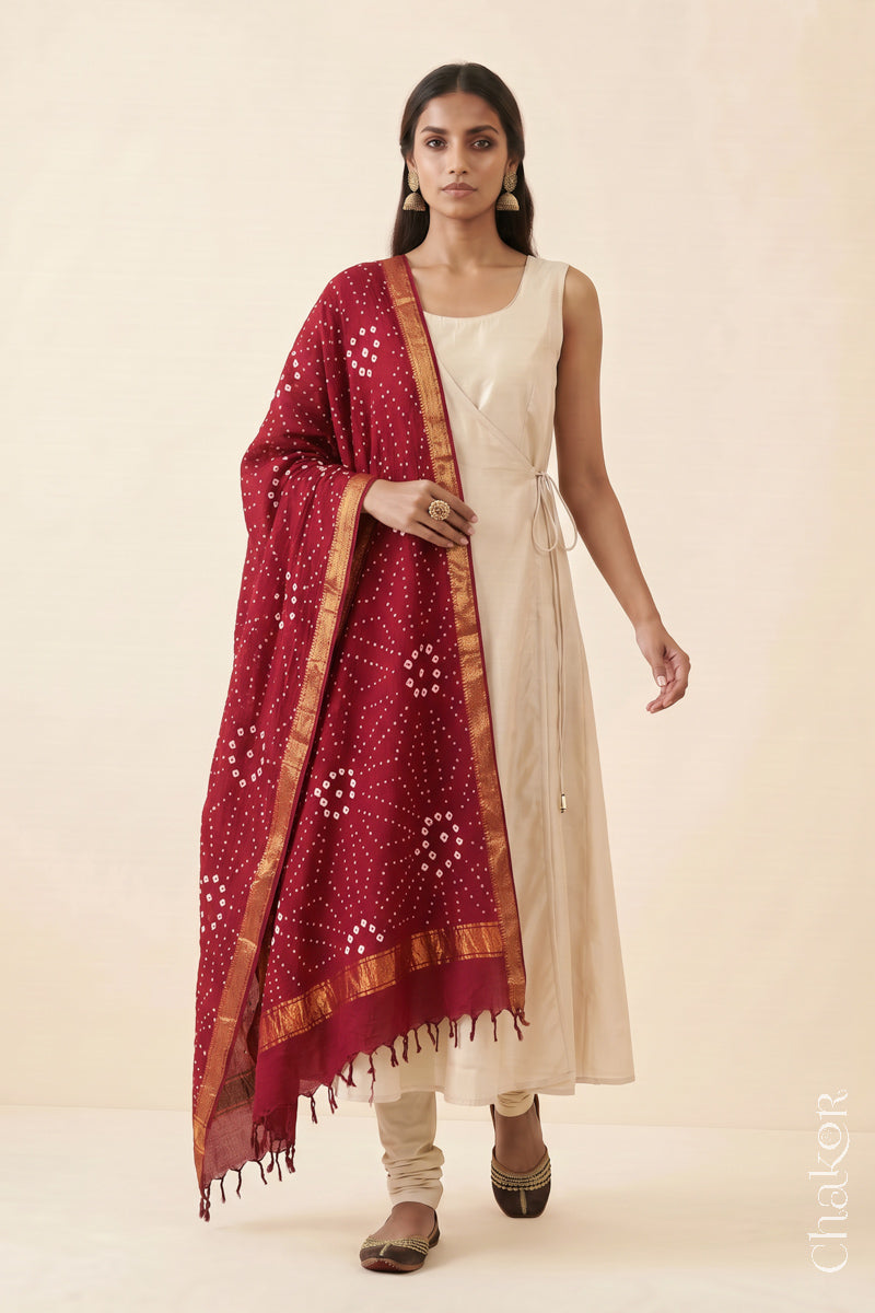 Red Bandhani handloom Mangalgiri cotton dupatta showing its white dotted pattern and zari border.
