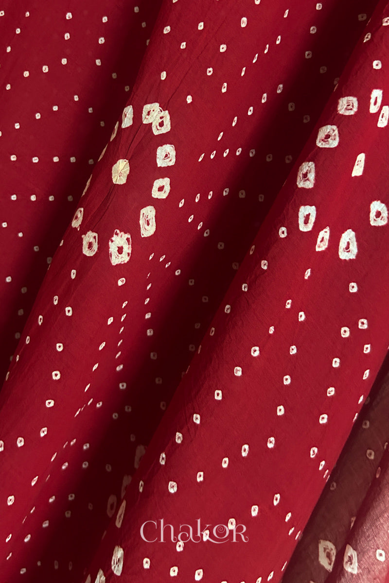 Close-up of Red Mangalgiri cotton fabric showing its handloom weave and opacity.
