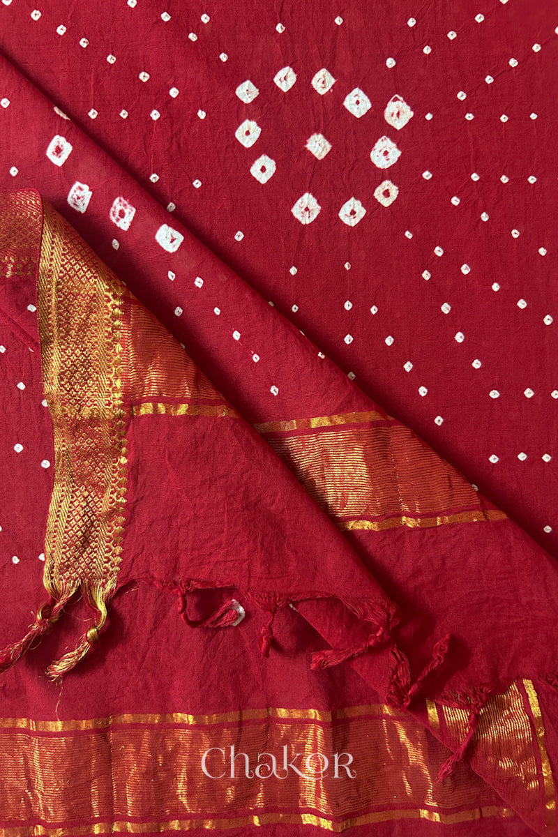 Red Bandhani Mangalgiri cotton dupatta flat view, showing the patterned pallu and golden zari detailing.
