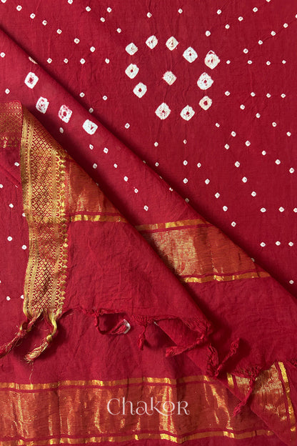 Red Bandhani Mangalgiri cotton dupatta flat view, showing the patterned pallu and golden zari detailing.
