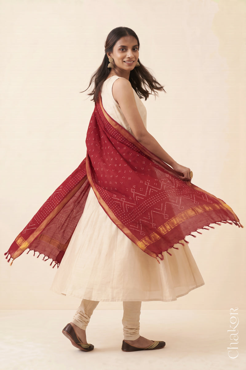 Red Bandhani handloom Mangalgiri cotton dupatta worn by a woman, shown in motion.

