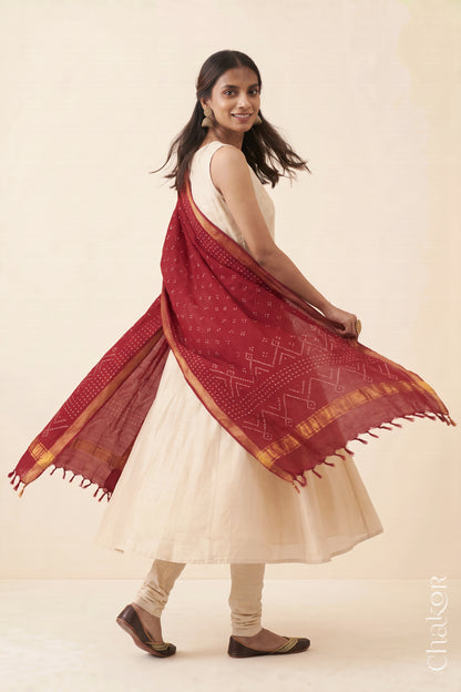 Red Bandhani handloom Mangalgiri cotton dupatta worn by a woman, shown in motion.

