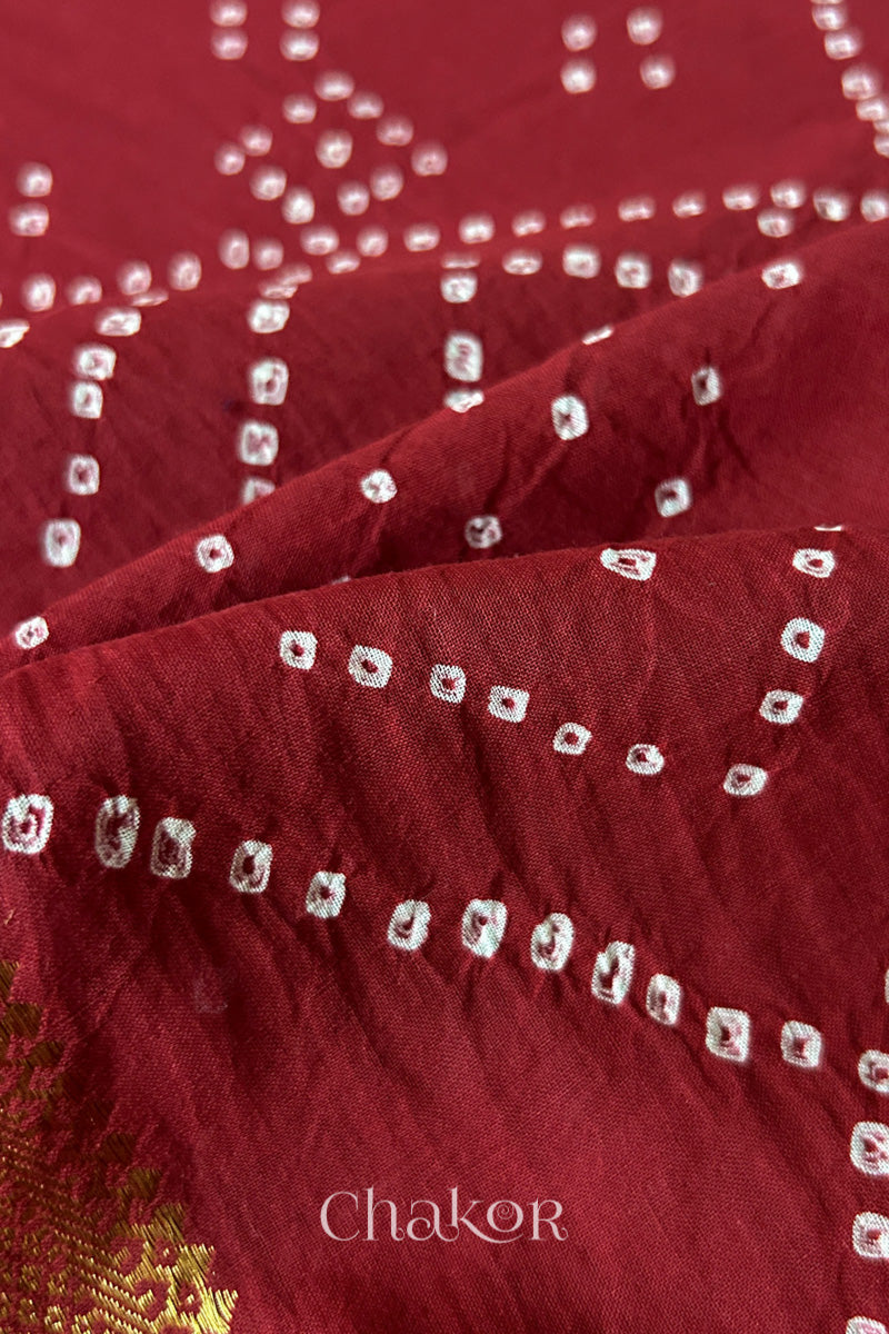 Close-up of white pearl-like dots in the Red Kutch Bandhani tie-dye pattern.
