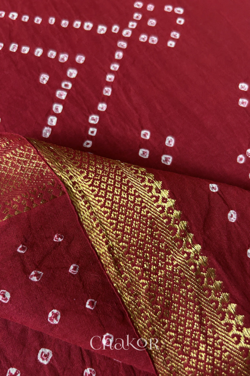 Close-up of the golden zari border on Red handloom Mangalgiri cotton Bandhani dupatta.

