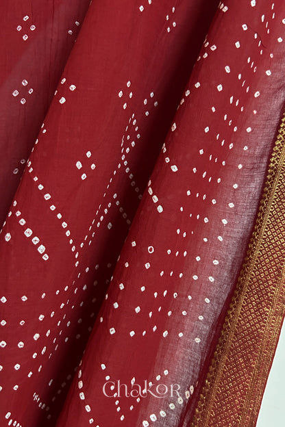 Close-up of Red Mangalgiri cotton fabric showing its handloom weave and opacity.
