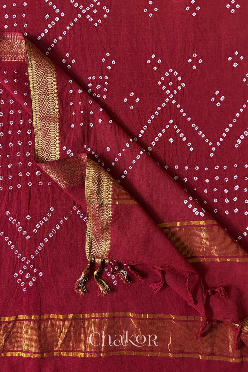 Red Bandhani Mangalgiri cotton dupatta flat view, showing the patterned pallu and golden zari detailing.
