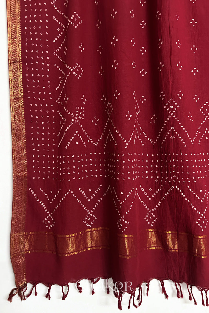 Red Bandhani Mangalgiri cotton dupatta, showing the draped of patterned pallu, golden zari detailing and tassels.
