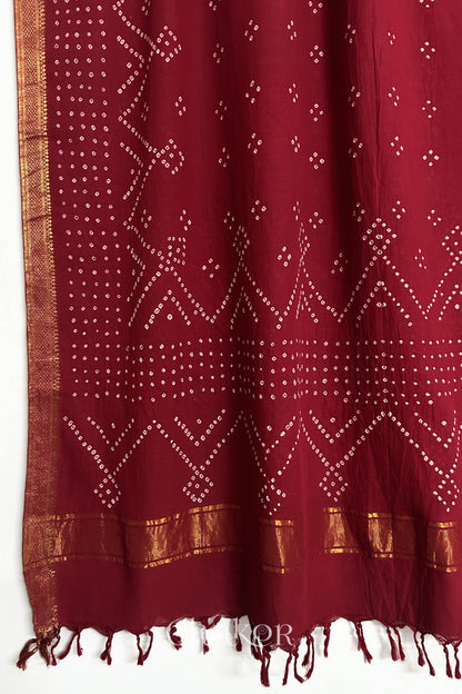 Red Bandhani Mangalgiri cotton dupatta, showing the draped of patterned pallu, golden zari detailing and tassels.
