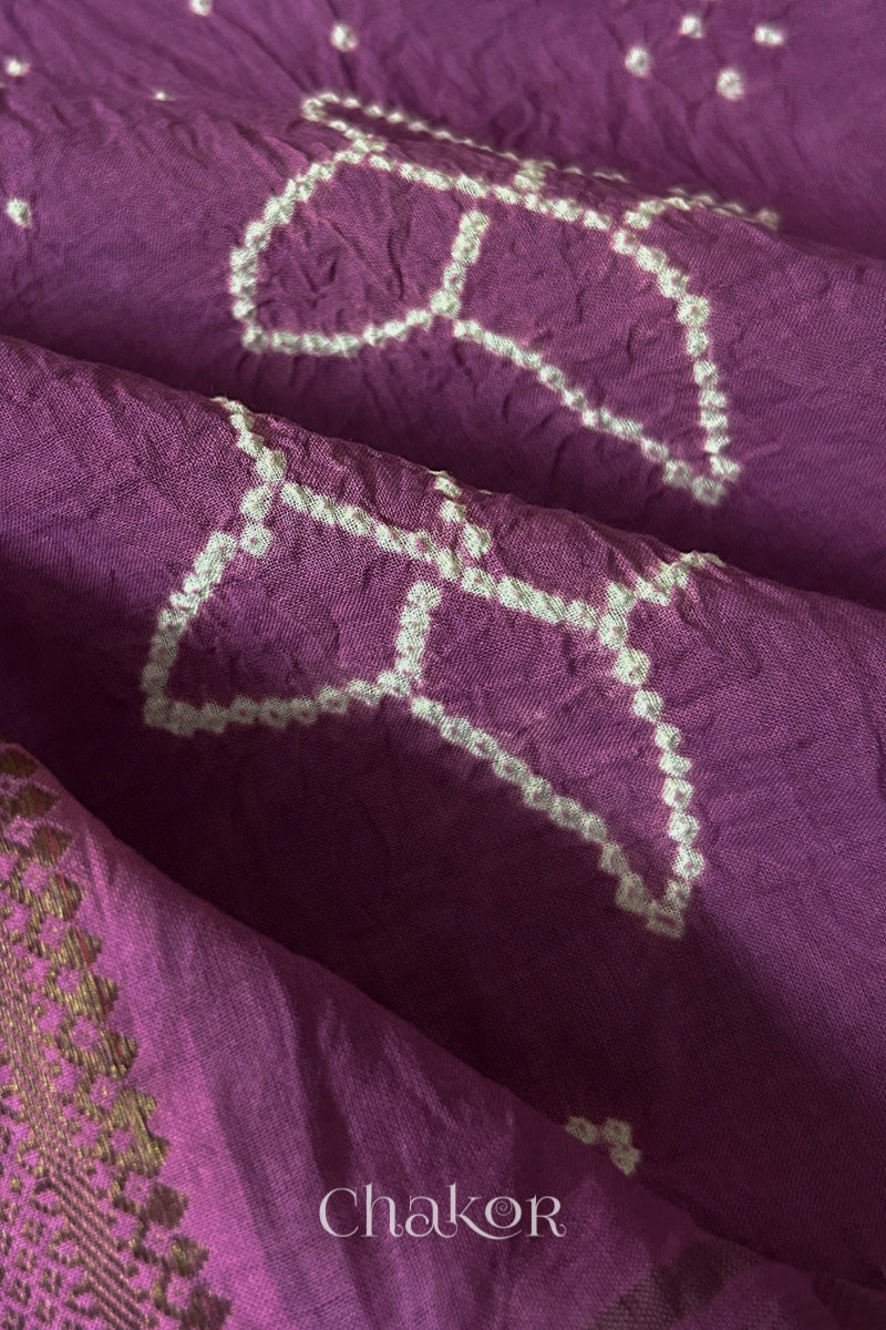 Close-up of white pearl-like dots in the Mauve Kutch Bandhani tie-dye pattern.
