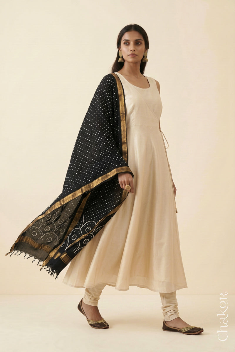 Black Bandhani Mangalgiri cotton dupatta worn by a woman, showing the zari border and pallu.
