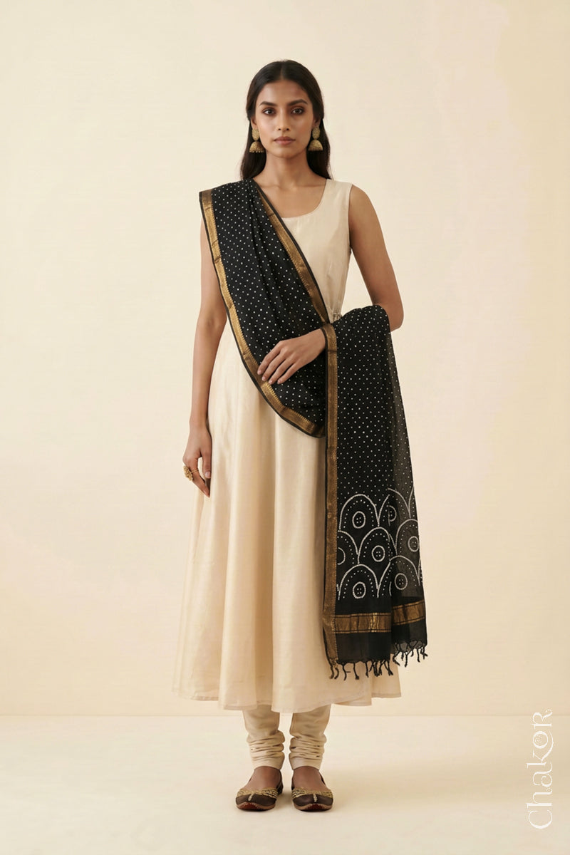 Black Bandhani handloom Mangalgiri cotton dupatta showing its white dotted pattern and zari border.
