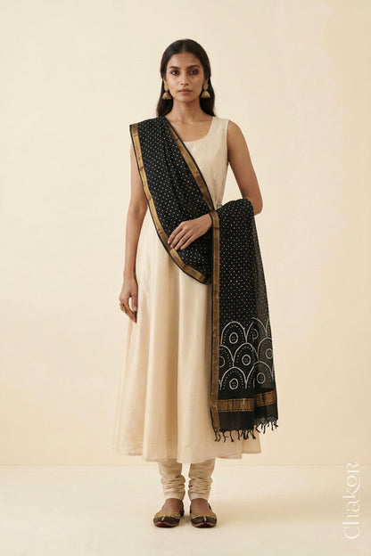 Black Bandhani handloom Mangalgiri cotton dupatta showing its white dotted pattern and zari border.
