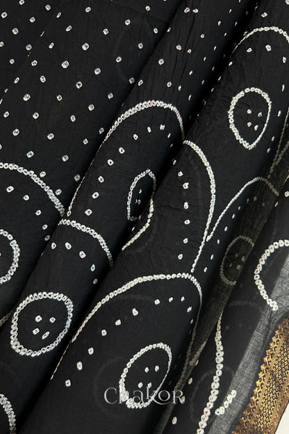 Close-up of Black Mangalgiri cotton fabric showing its handloom weave and opacity.

