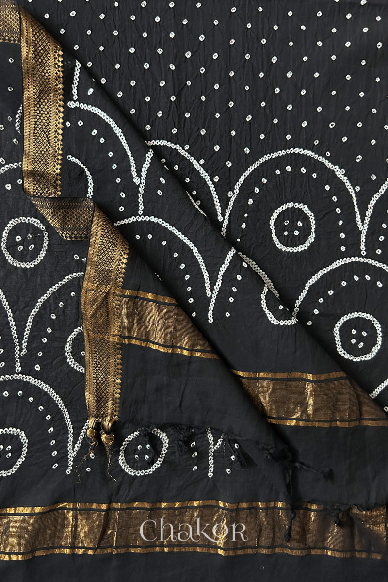 Black Bandhani Mangalgiri cotton dupatta flat view, showing the patterned pallu and golden zari detailing.
