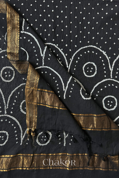 Black Bandhani Mangalgiri cotton dupatta flat view, showing the patterned pallu and golden zari detailing.

