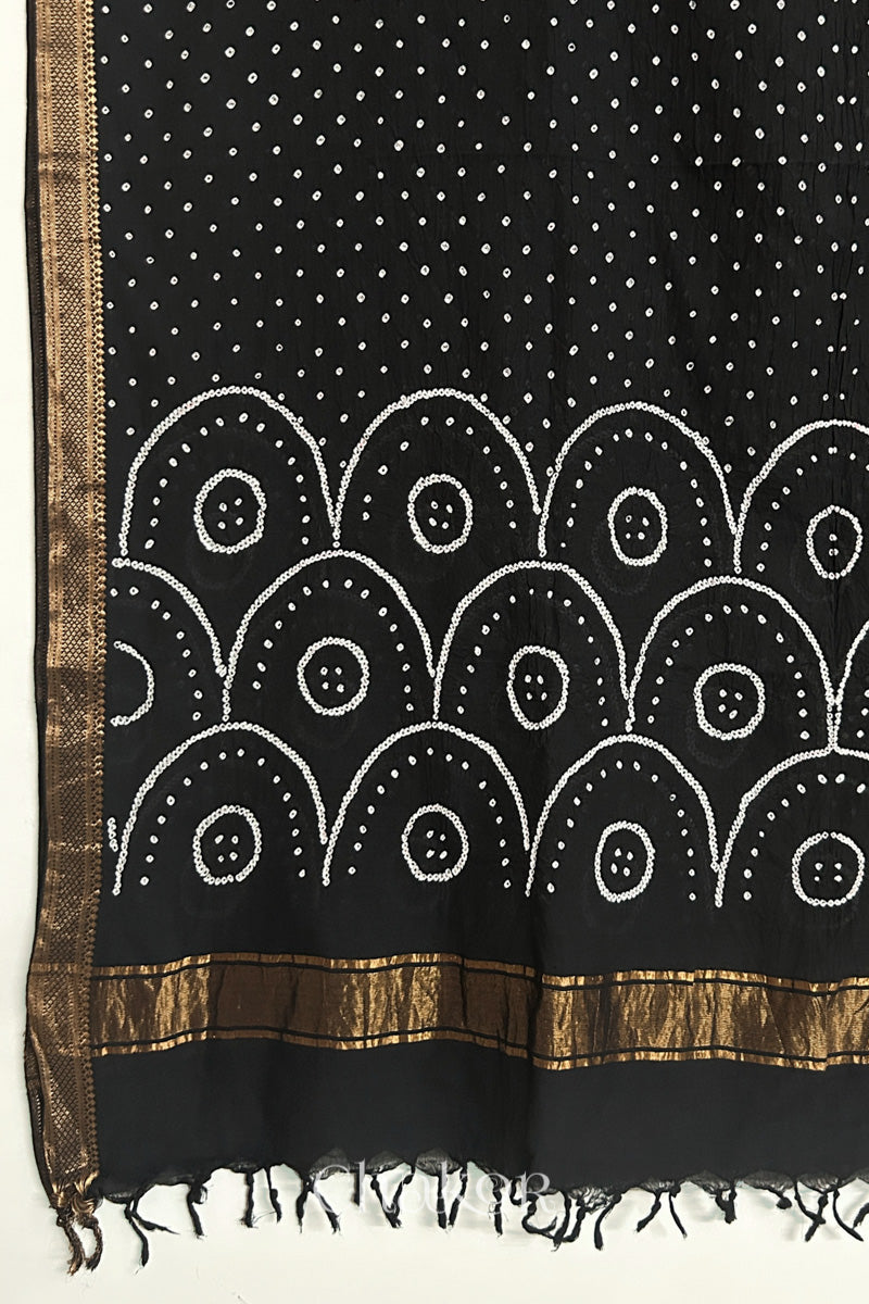 Black Bandhani Mangalgiri cotton dupatta, showing the draped of patterned pallu, golden zari detailing and tassels.
