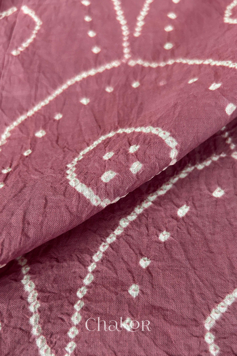 Close-up of white pearl-like dots in the Old Rose Pink Kutch Bandhani tie-dye pattern.
