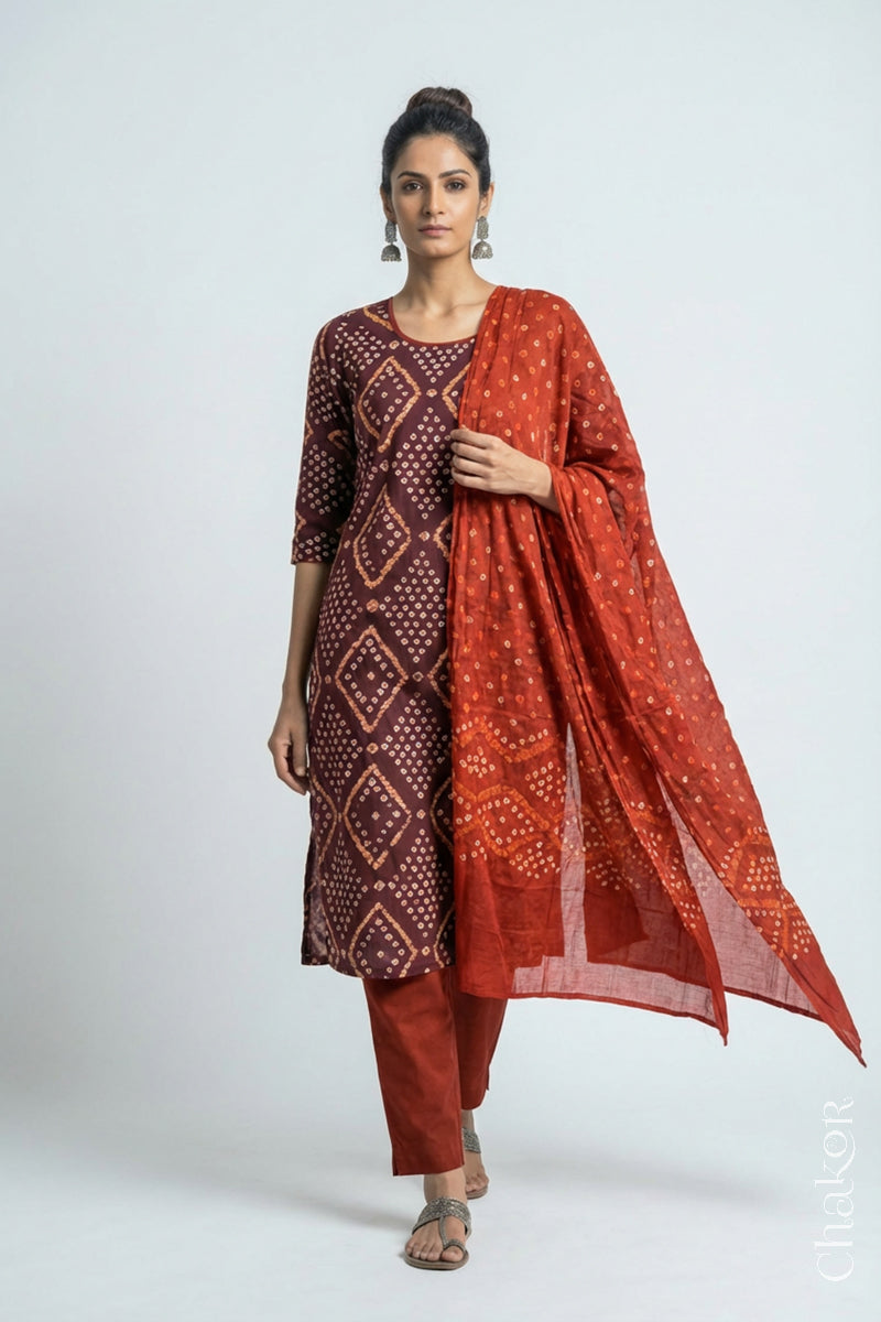 Model wearing Handcrafted Brown Bandhani Cotton Kurta and Rust Pant Set with Dupatta with traditional design and hand embroidery.