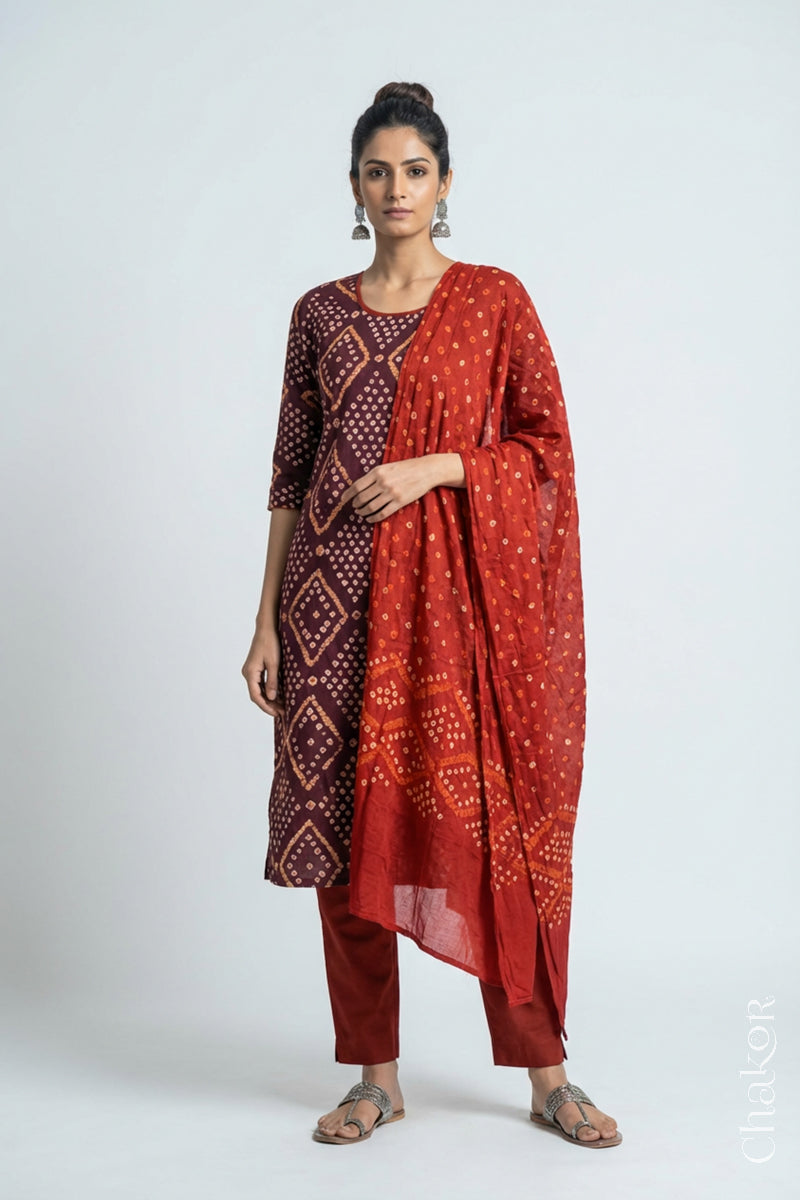 Model wearing Handcrafted Brown Bandhani Cotton Kurta and Rust Pant Set with Dupatta with traditional design and hand embroidery.