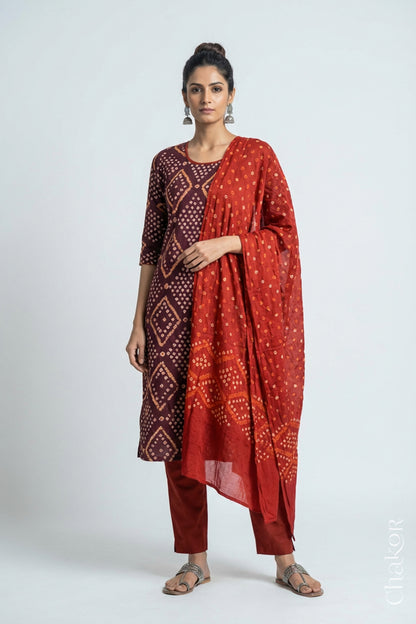 Model wearing Handcrafted Brown Bandhani Cotton Kurta and Rust Pant Set with Dupatta with traditional design and hand embroidery.