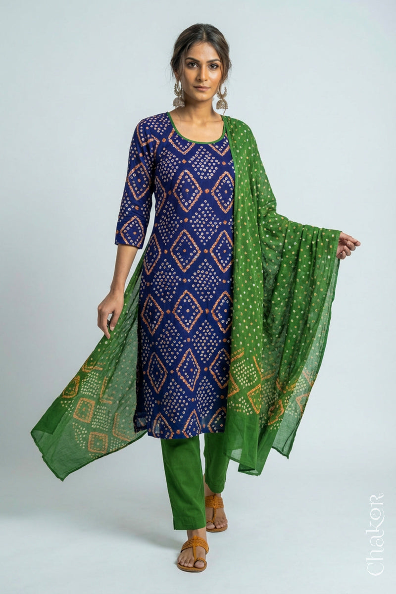 Model wearing Handcrafted Blue Bandhani Cotton Kurta and Mehendi green Pant Set with Dupatta with traditional design and hand embroidery.