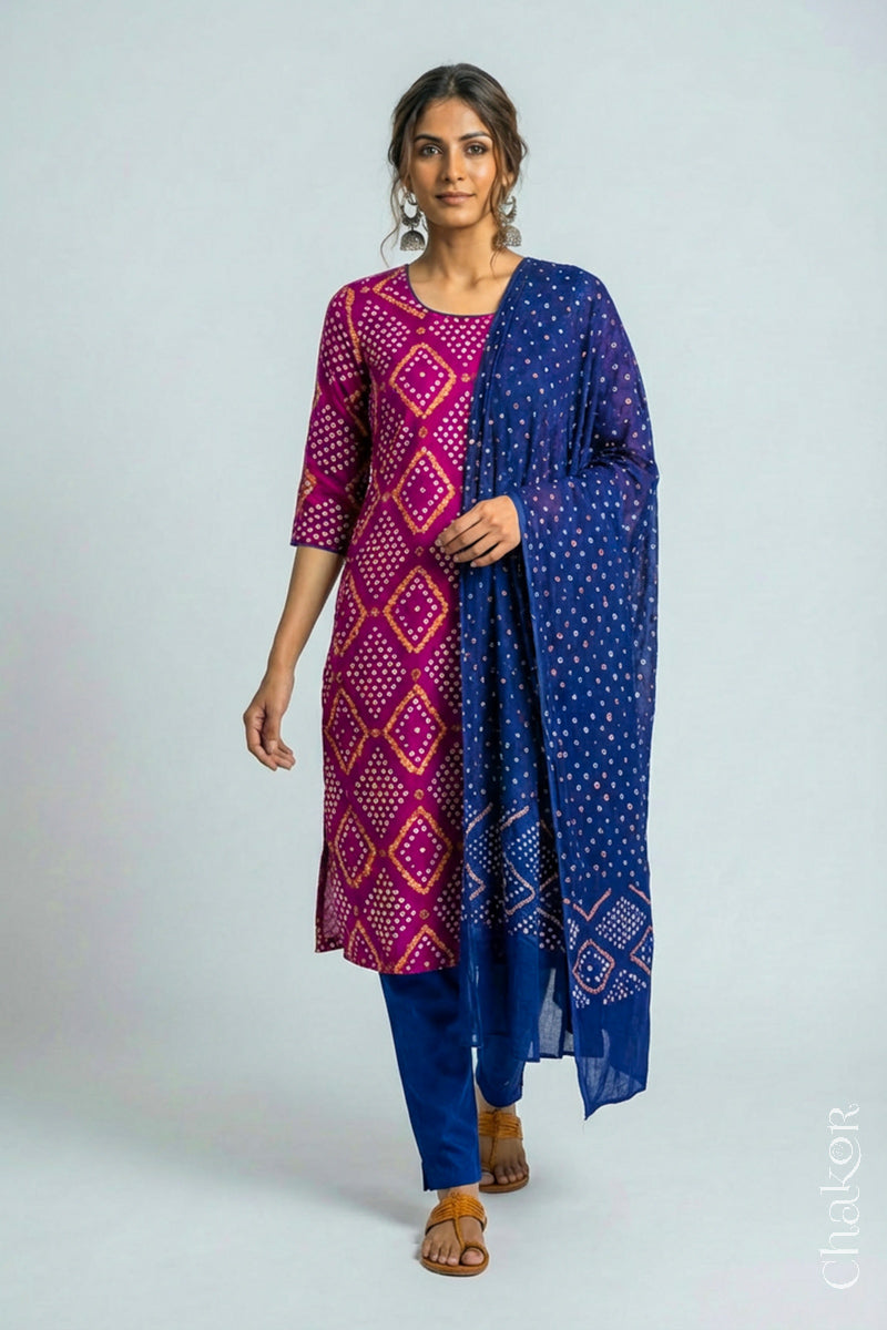 Model wearing Handcrafted Magenta Bandhani Cotton Kurta and Blue Pant Set with Dupatta with traditional design and hand embroidery.