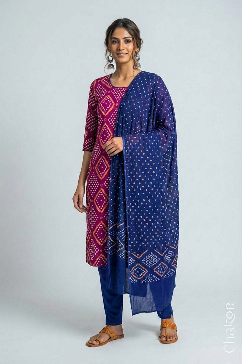 Model wearing Handcrafted Magenta Bandhani Cotton Kurta and Blue Pant Set with Dupatta with traditional design and hand embroidery.