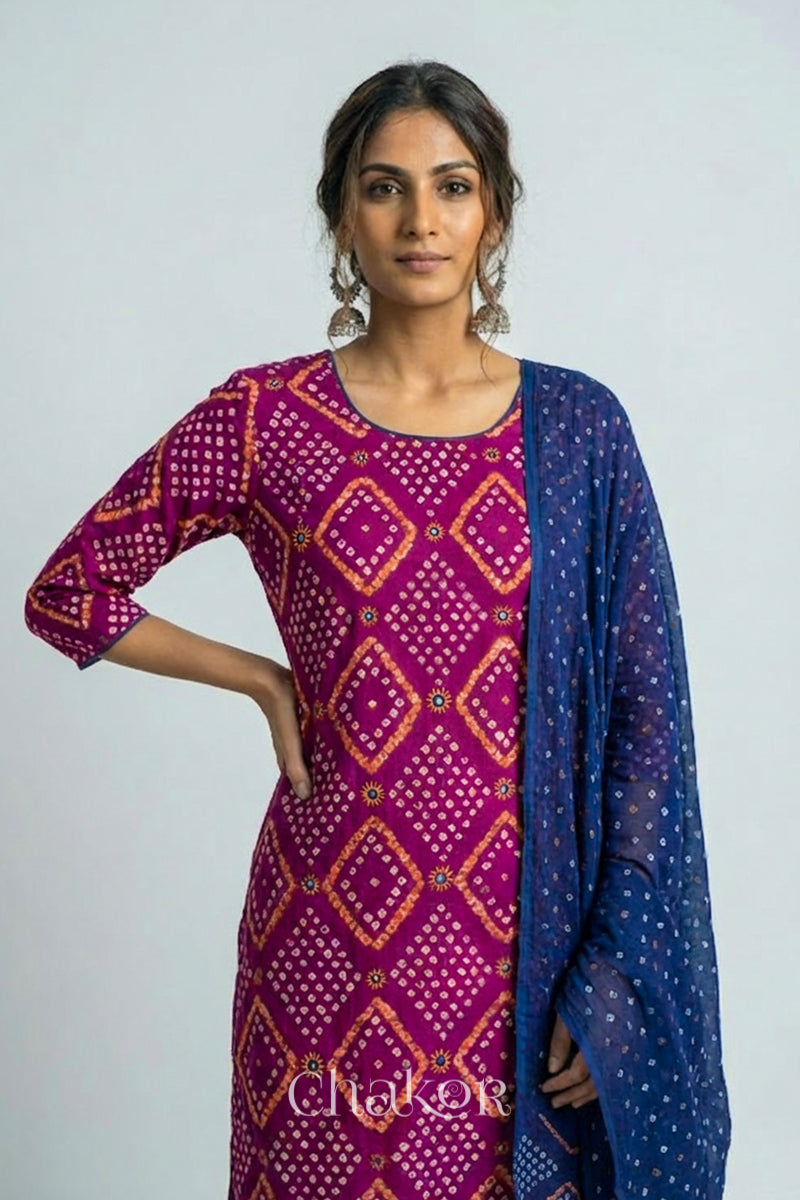 Model wearing Handcrafted Magenta Bandhani Cotton Kurta and Blue Pant Set with Dupatta with traditional design and hand embroidery.