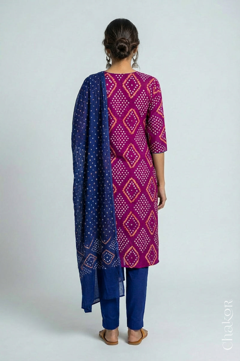 Model wearing Handcrafted Magenta Bandhani Cotton Kurta and Blue Pant Set with Dupatta with traditional design and hand embroidery.