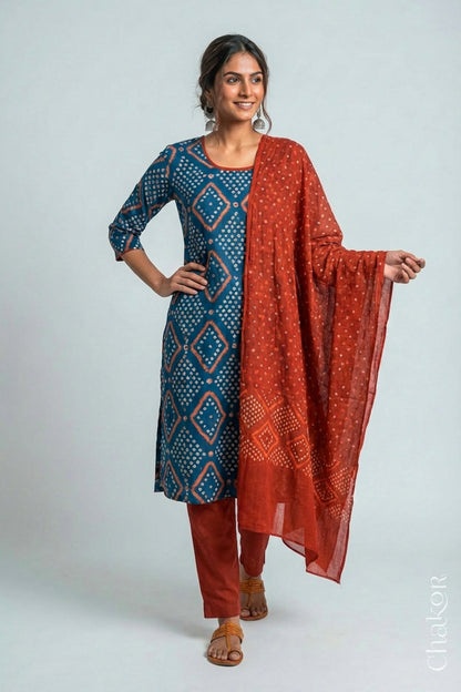 Model wearing Handcrafted Indigo Blue Bandhani Cotton Kurta and Rust Pant Set with Dupatta with traditional design and hand embroidery.