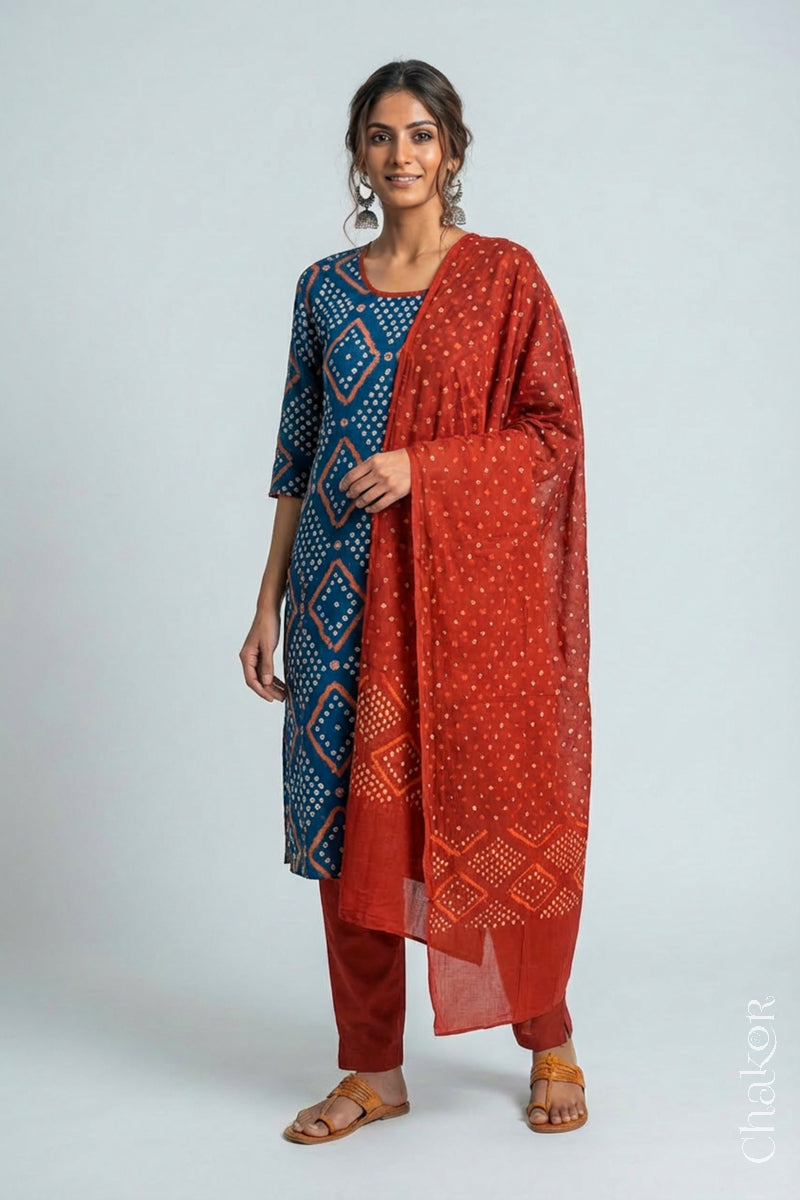Model wearing Handcrafted Indigo Blue Bandhani Cotton Kurta and Rust Pant Set with Dupatta with traditional design and hand embroidery.