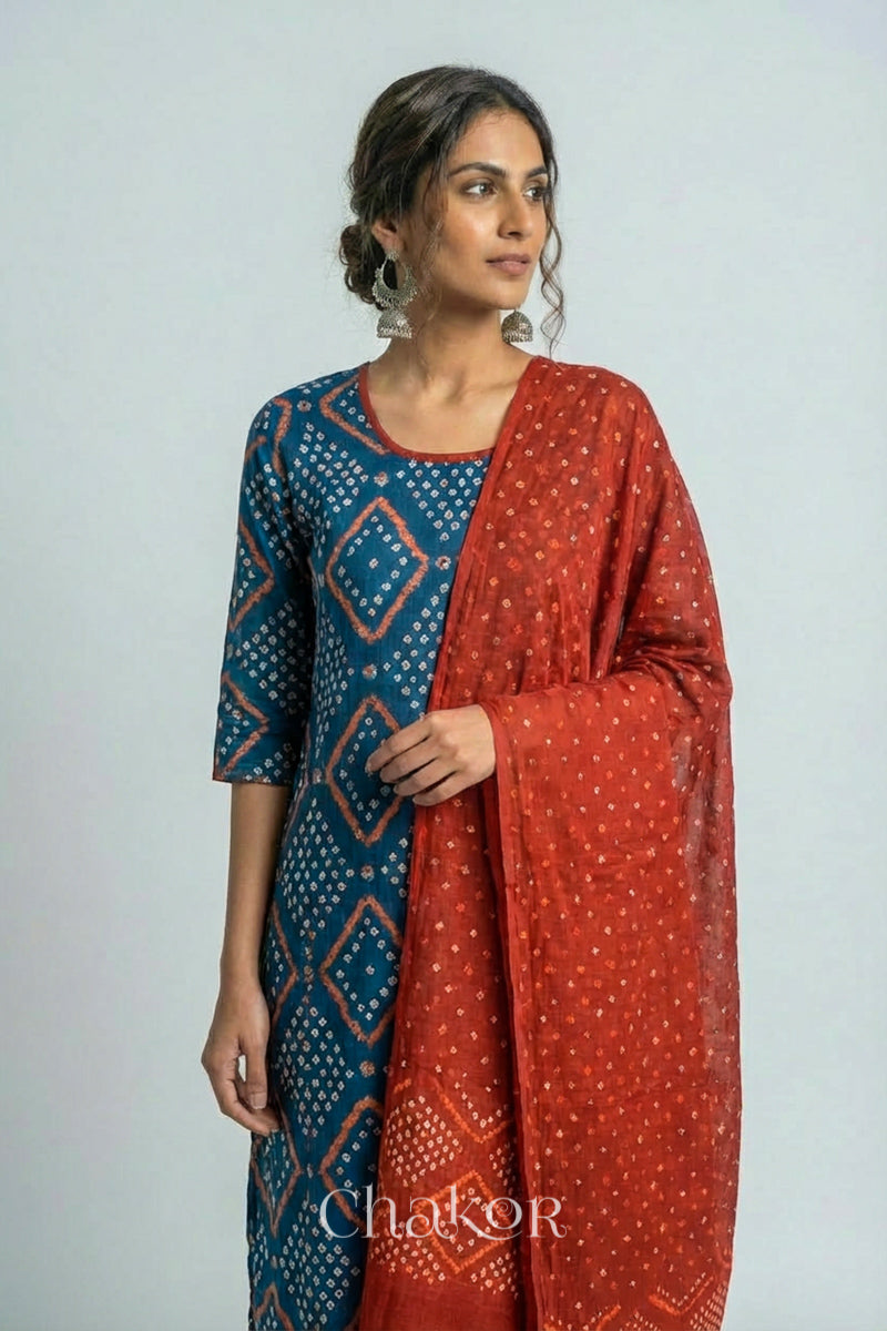 Model wearing Handcrafted Indigo Blue Bandhani Cotton Kurta and Rust Pant Set with Dupatta with traditional design and hand embroidery.