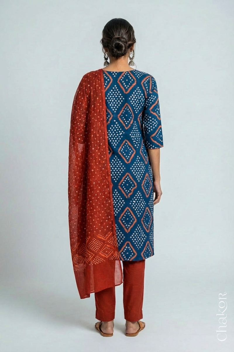 Model wearing Handcrafted Indigo Blue Bandhani Cotton Kurta and Rust Pant Set with Dupatta with traditional design and hand embroidery.