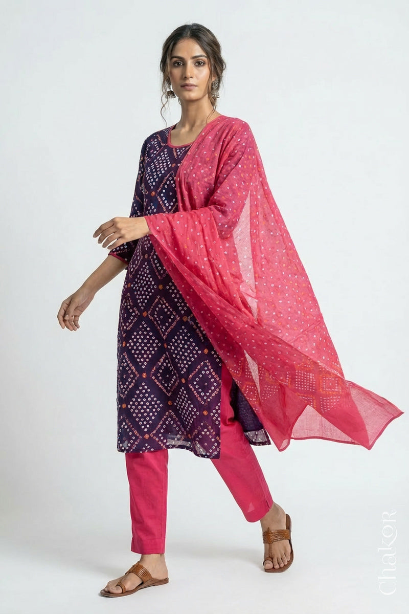Model wearing Handcrafted Purple Bandhani Cotton Kurta and Pink Pant Set with Dupatta with traditional design and hand embroidery.