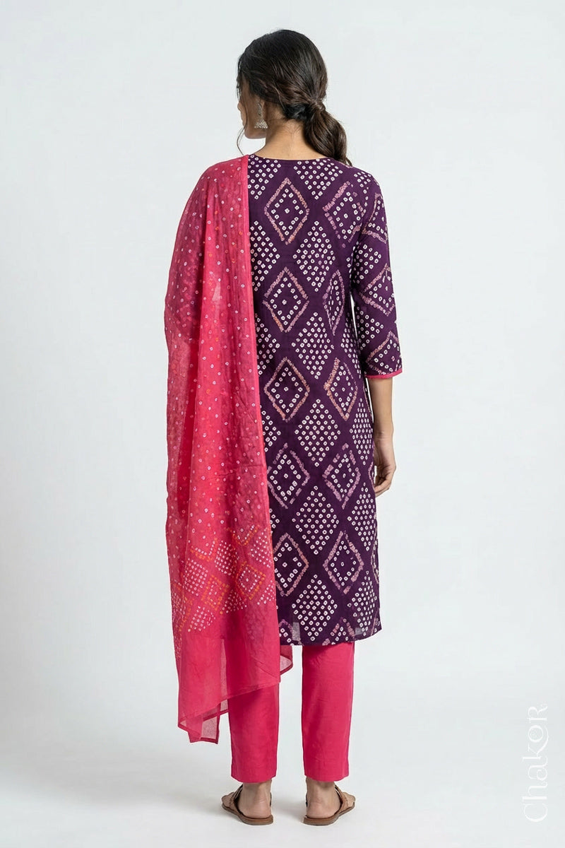 Model wearing Handcrafted Purple Bandhani Cotton Kurta and Pink Pant Set with Dupatta with traditional design and hand embroidery.