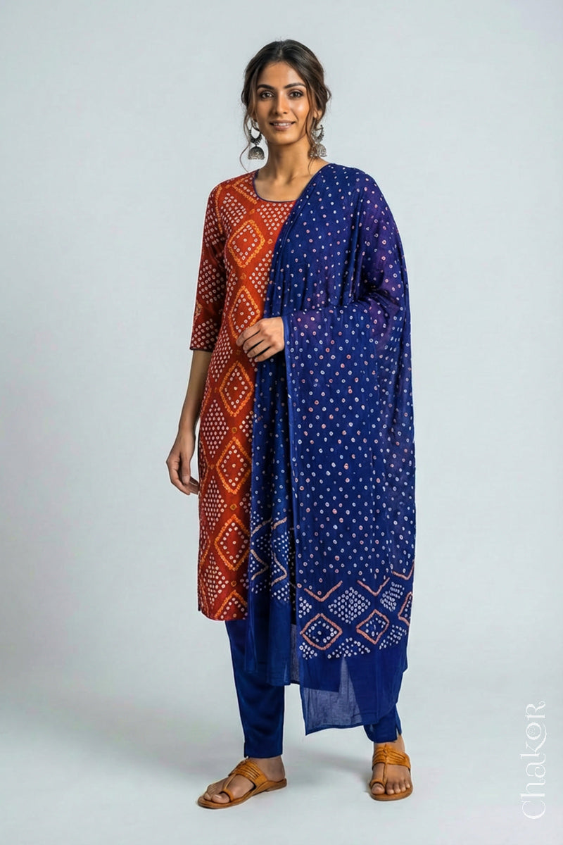 Model wearing Handcrafted Rust Bandhani Cotton Kurta and Blue Pant Set with Dupatta with traditional design and hand embroidery.