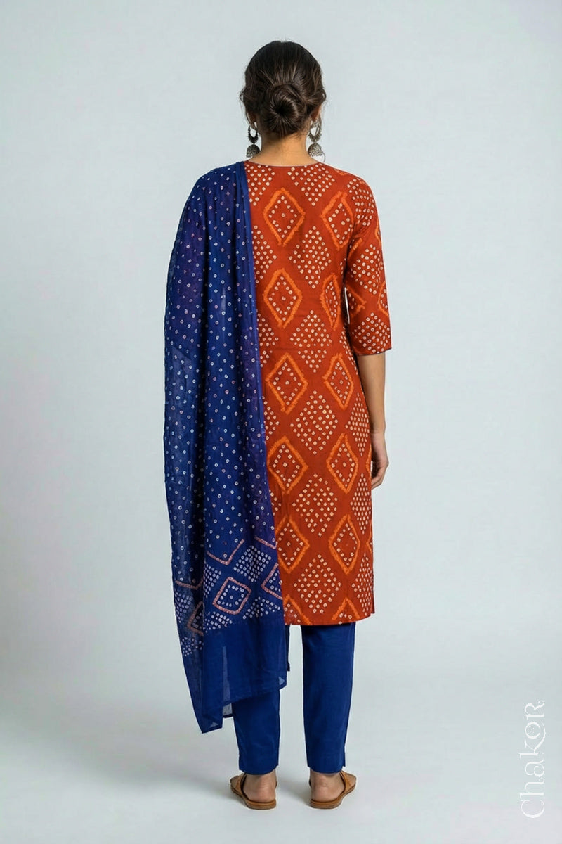 Model wearing Handcrafted Rust Bandhani Cotton Kurta and Blue Pant Set with Dupatta with traditional design and hand embroidery.