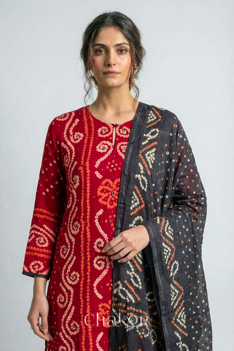 Model wearing Red Bandhani Cotton Tunic with Charcoal gray Pant with Dupatta, Handcrafted in Kutch with traditional design and hand embroidery.