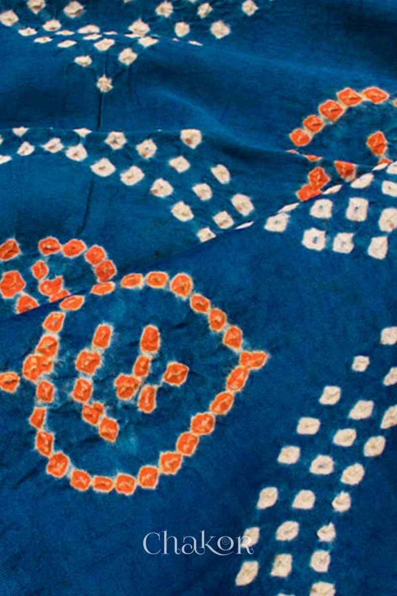 Close of handcrafted Indigo blue and rust Kurta Set and a matching dupatta with traditional bandhani tie-dye patterns.