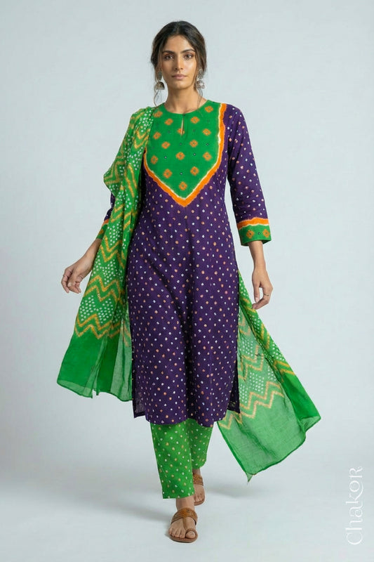 Model wearing Handcrafted Purple Mehendi Bandhani Cotton Kurta Set with kutch hand embroidery and paired with laher pattern Dupatta. 