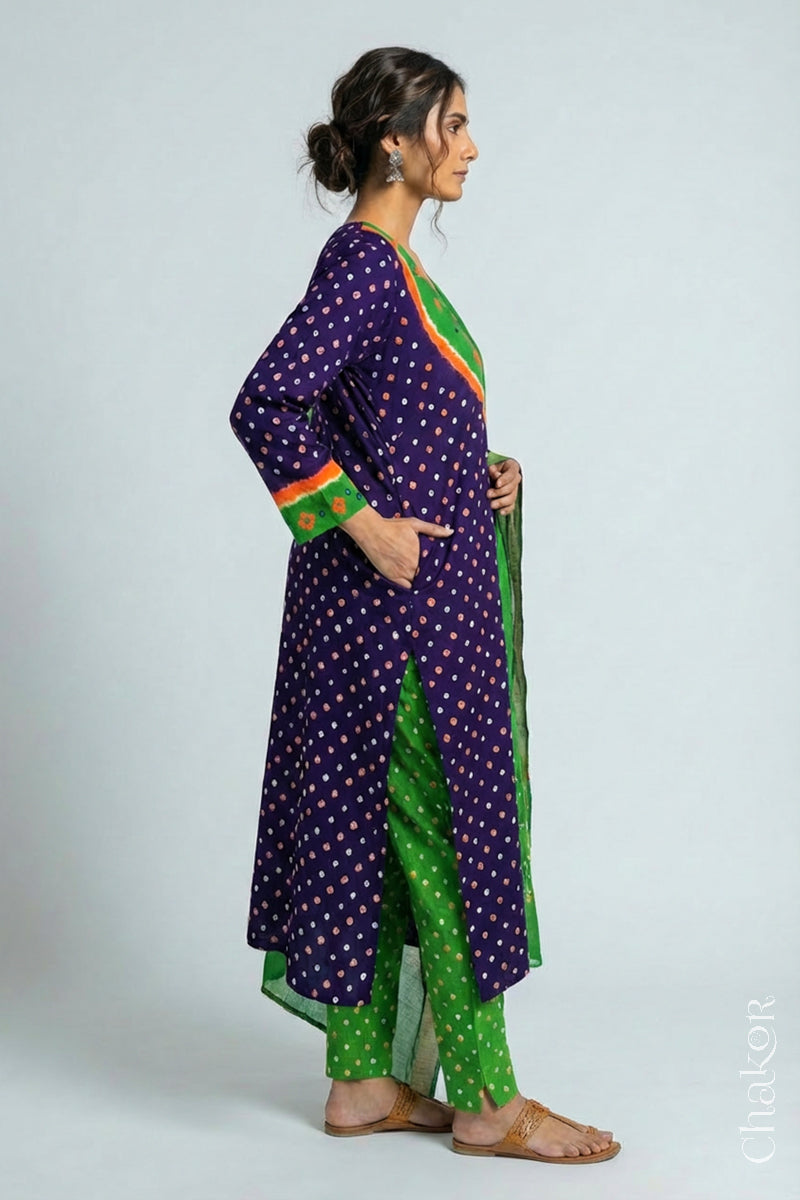Model wearing Handcrafted Purple Mehendi Bandhani Cotton Kurta Set with kutch hand embroidery and paired with laher pattern Dupatta. 