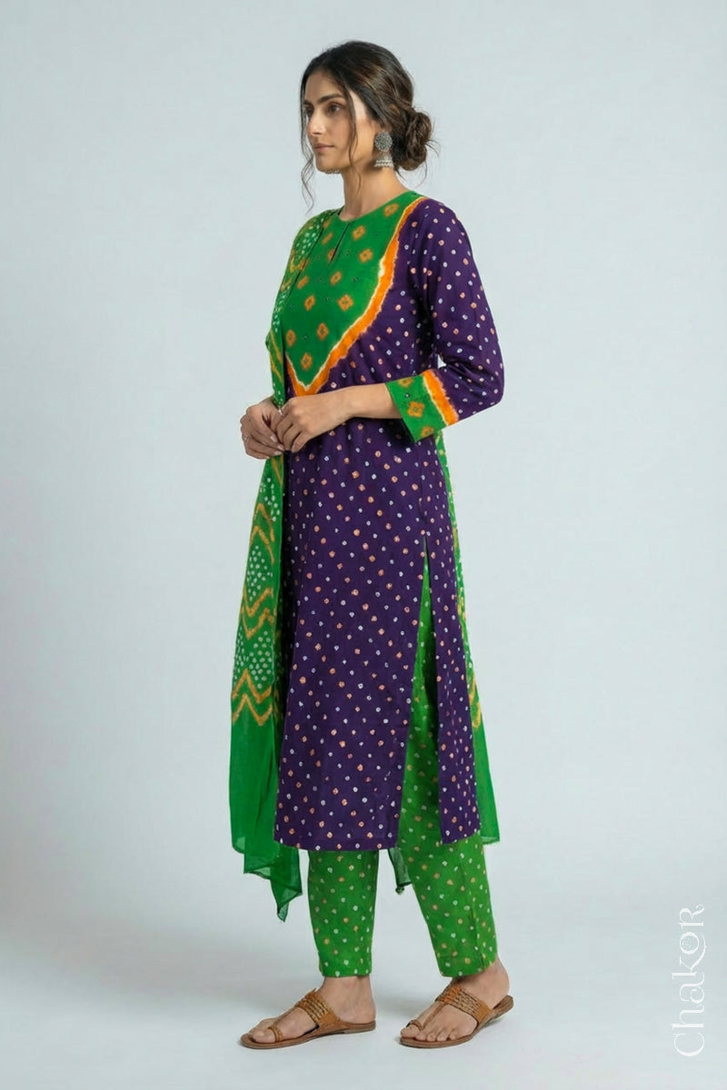 Model wearing Handcrafted Purple Mehendi Bandhani Cotton Kurta Set with kutch hand embroidery and paired with laher pattern Dupatta. 