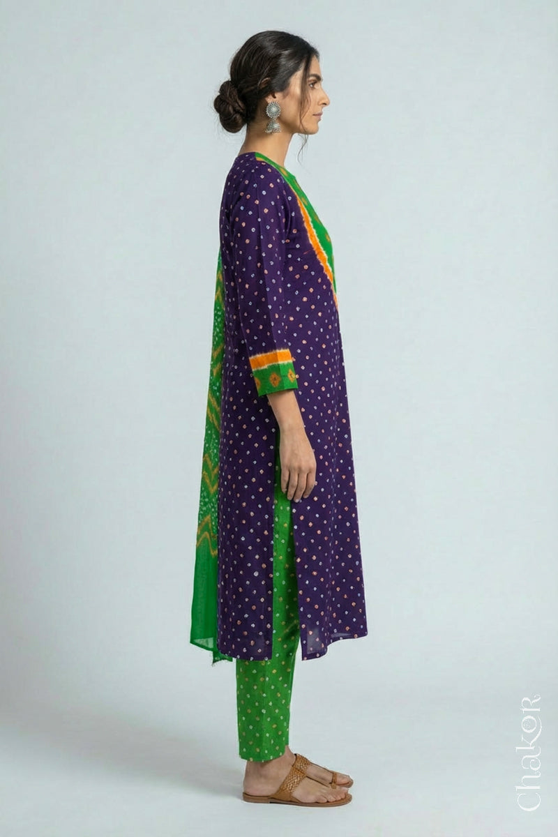 Model wearing Handcrafted Purple Mehendi Bandhani Cotton Kurta Set with kutch hand embroidery and paired with laher pattern Dupatta. 