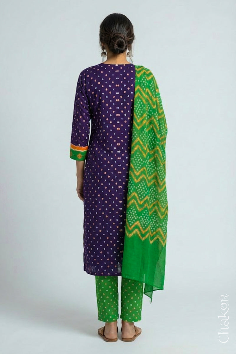 Model wearing Handcrafted Purple Mehendi Bandhani Cotton Kurta Set with kutch hand embroidery and paired with laher pattern Dupatta. 