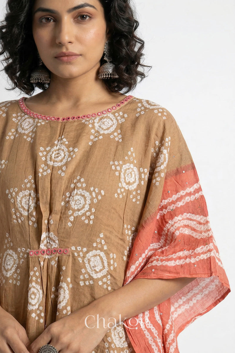 Bandhani kaftan neckline with mirror work detail in beige and rust mulmul cotton for summer.
