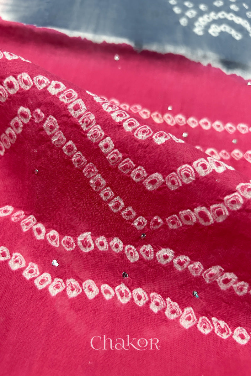 Mulmul cotton bandhani fabric with mukaish embroidery detail in bluish grey and pink.
