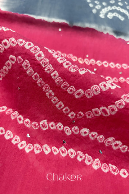 Mulmul cotton bandhani fabric with mukaish embroidery detail in bluish grey and pink.
