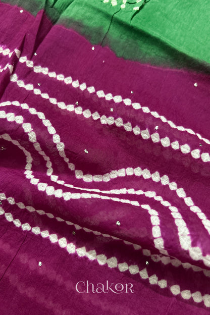 Mulmul cotton bandhani fabric with mukaish embroidery detail in green and magenta.
