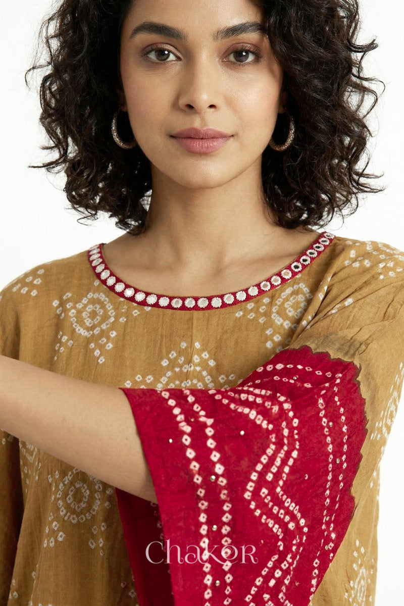 Bandhani kaftan neckline with mirror work detail in mustard and red mulmul cotton for summer.
