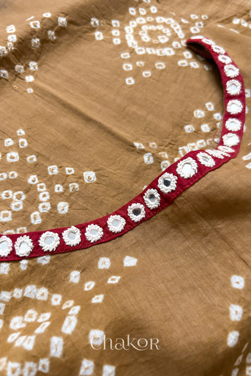 Mirror work neckline detail on mulmul cotton bandhani kaftan in mustard and red, handcrafted in Kutch.
